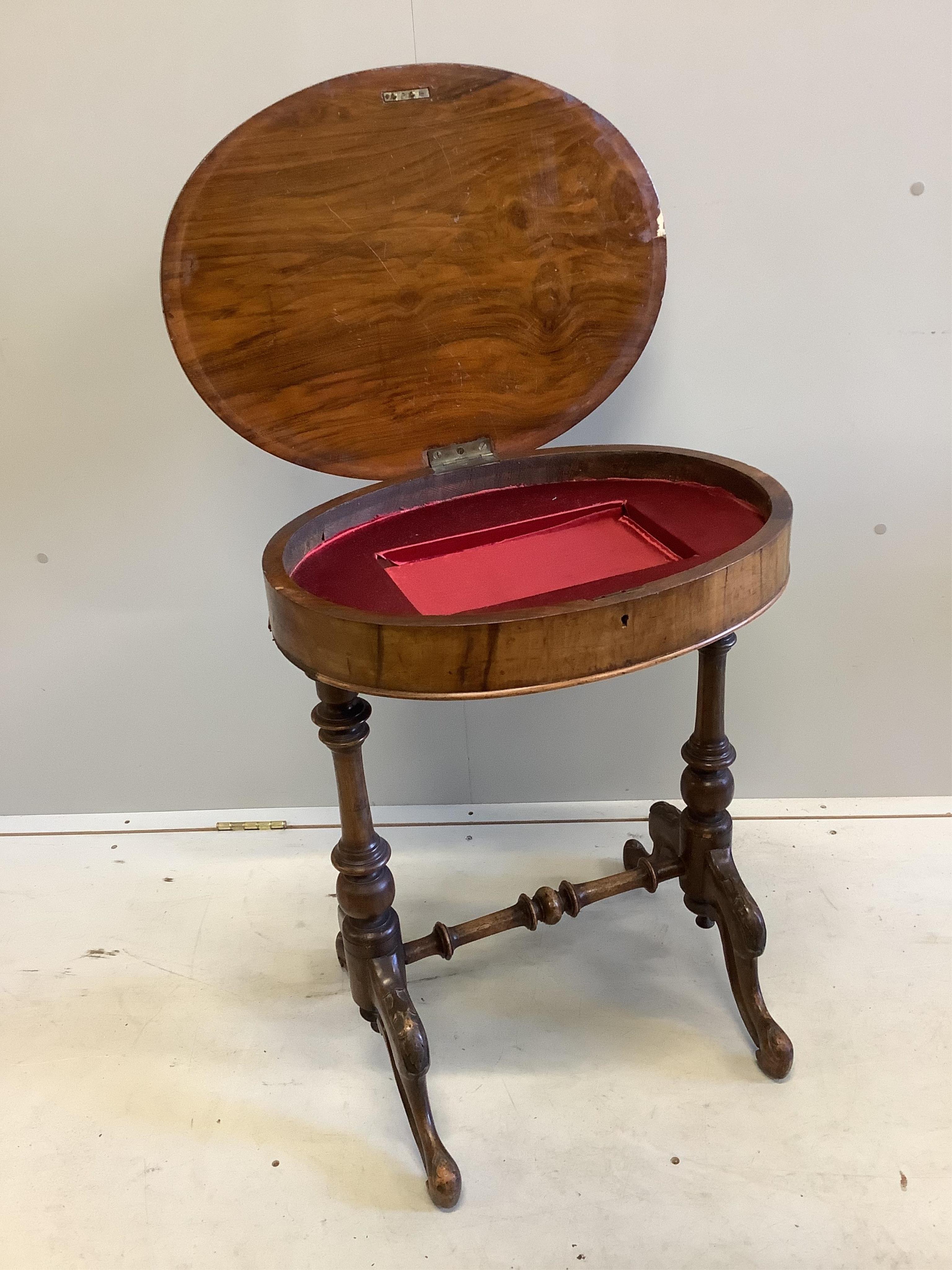 A Victorian oval walnut topped work table, width 56cm, depth 44cm, height 68cm. Condition - fair